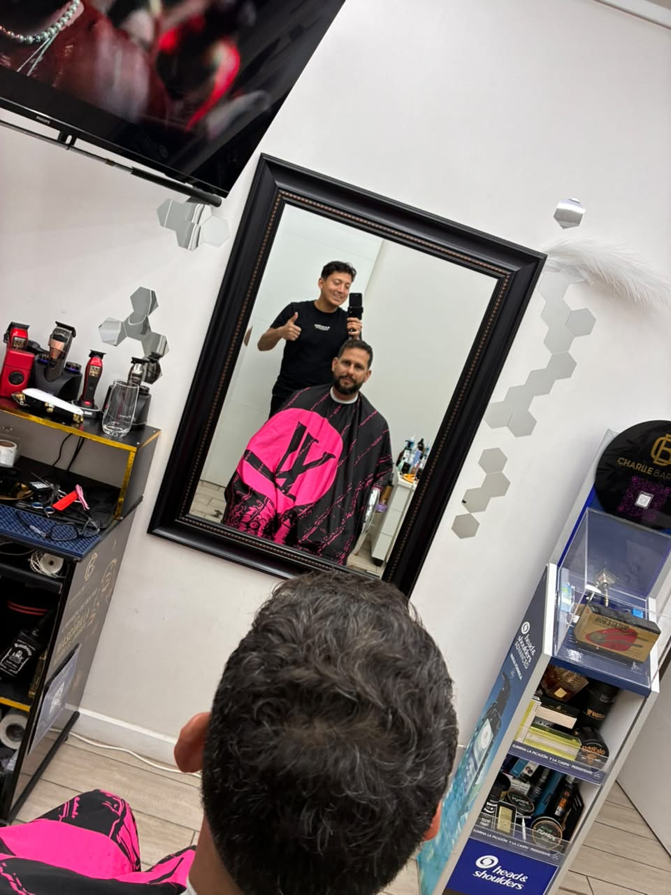 Momento de Charlie junto a un cliente en la barbería, fotografía 1